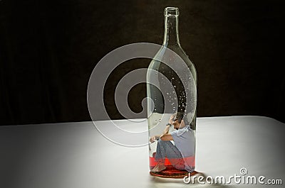 Man addicted to alcohol trapped by alcoholism Stock Photo