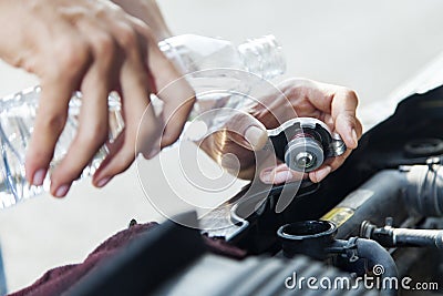 Man adding water to car radiator Stock Photo