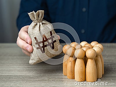 Man adjusts and south korean won money bag to a crowd of people. Stock Photo
