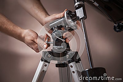 Man adjusts a telescope closeup Stock Photo