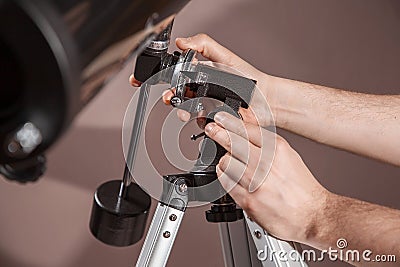 Man adjusts a telescope closeup Stock Photo