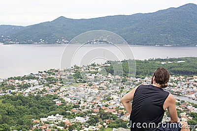 a man admires a beautiful view of the lake Lagoa da Conceicao in Santa catarina, florianopolis, Brazil Editorial Stock Photo