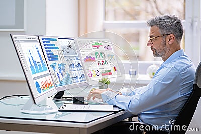 Man Advisor Using Multiple Computer Monitors Stock Photo