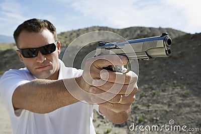 Man Aiming Hand Gun Stock Photo