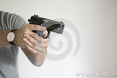 Man aiming Handgun from Holster in Self Defense Stock Photo