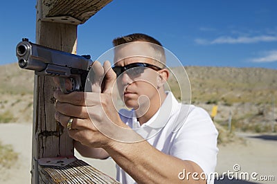 Man Aiming Machine Gun At Firing Range Stock Photo