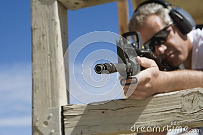 Man Aiming Machine Gun At Firing Range Stock Photo