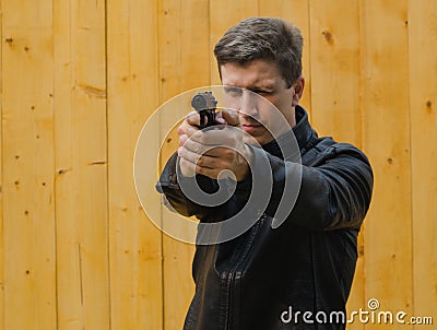 The man aims from a pistol Stock Photo