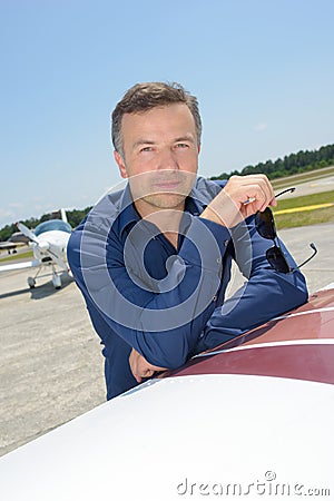 Man with airplane in background Stock Photo