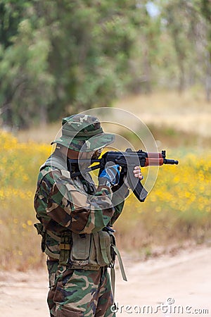 Man with AK holds at gunpoint Stock Photo