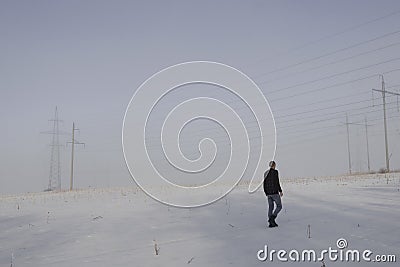 Man alone foggy snowy field day alone Editorial Stock Photo