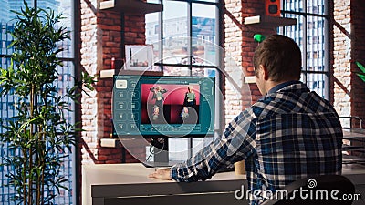 Man in apartment workspace using AI software turning text prompt into photos Stock Photo