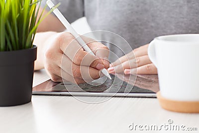 Man with Apple Pencil drawing on the iPad Pro Editorial Stock Photo