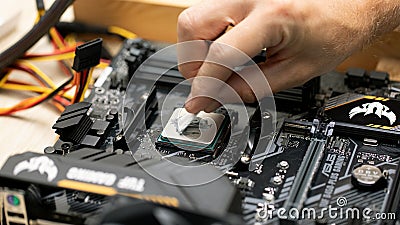 man apply thermal paste on microprocessor. Maintenance computer cpu hardware. Russia, 17.08.2021 Editorial Stock Photo