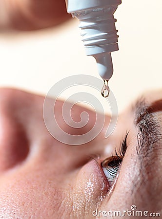 Man applying eyedrops Stock Photo