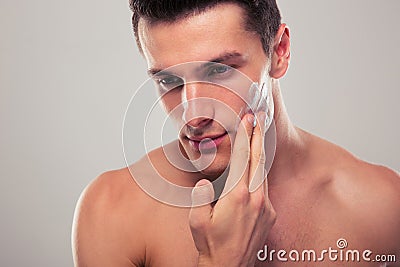 Man applying facial cream Stock Photo