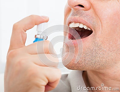 Man applying fresh breath spray Stock Photo