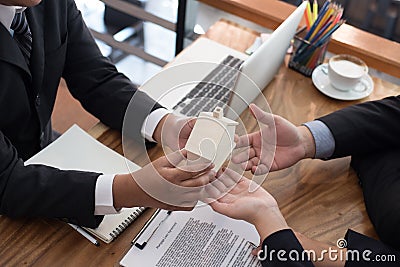 man applying for mortgage loan with bank employee. client signing contract document with realtor at real estate agency. Stock Photo