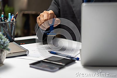 Man approving documents finance, banking, investments, marketing on desk. contract law, or rubber stamping business real estate Stock Photo