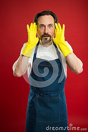 Man in apron with gloves cleaning agent. Cleaning day today. Bearded guy cleaning home. On guard of cleanliness and Stock Photo