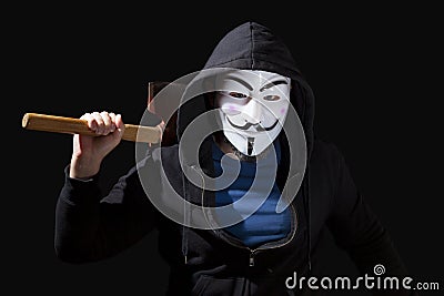 Man armed with an axe and wearing a Guy Fawkes mask Editorial Stock Photo