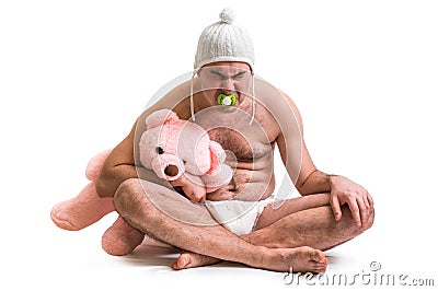 Man as baby. Child in diaper with pink teddy bear. Stock Photo