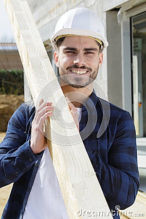 man as builder carrying wood Stock Photo