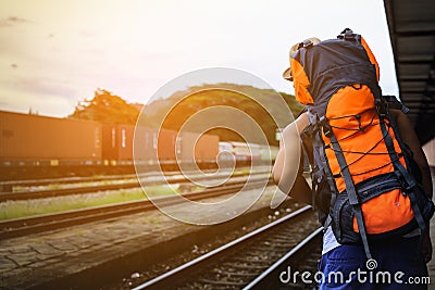 Man Asian backpack looking train at train station in Thailand. Stock Photo