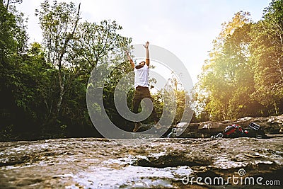 Man asians travel relax in the holiday. Walk in the forest. Relax on the rocks. stream dry waterfall caught hole Giants kettles. Stock Photo