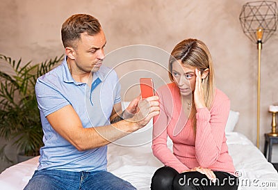 Man asks his woman to explain her messages Stock Photo