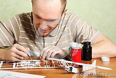 Man assembling plastic airplane model Stock Photo