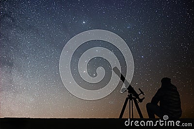 Man with astronomy telescope looking at the stars. Stock Photo