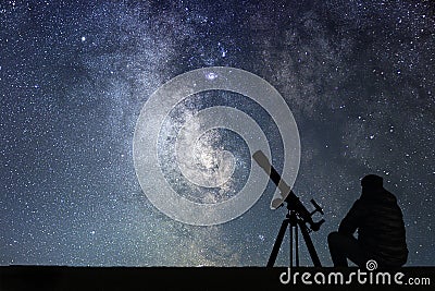 Man with astronomy telescope looking at the stars. Stock Photo