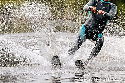 man athlete waterskiing behind motorboat on lake Stock Photo