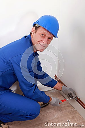 Man attaching copper pipe Stock Photo
