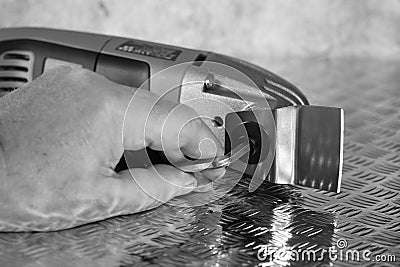 Man attaching cutting blade on an electric multi tool cutter sander. Stock Photo