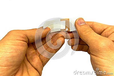 man attaching a plaster Stock Photo