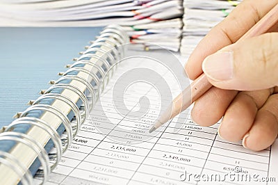 Man is auditing account by pencil with notebook Stock Photo