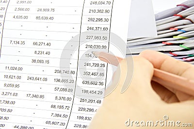 Man auditing account by pencil with pile of report Stock Photo