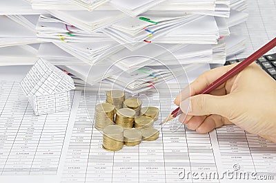 Man is auditing account with step gold coins Stock Photo