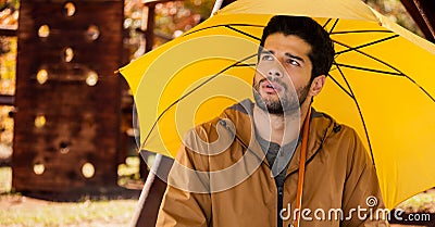 Man in Autumn with umbrella in wood park Stock Photo