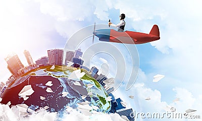 Man in aviator hat with goggles driving plane Stock Photo