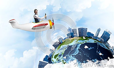 Man in aviator hat with goggles driving plane Stock Photo