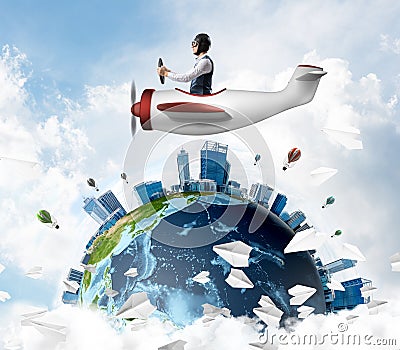 Man in aviator hat with goggles driving plane Stock Photo
