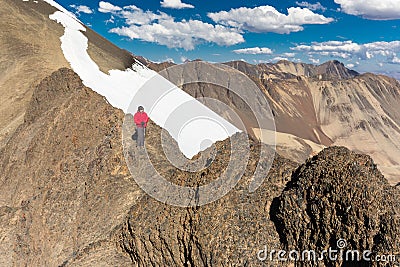 Man backpacker mountaineer standing mountain snow ridge peak, Bolivia Stock Photo