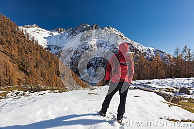 Man is backpacking in winter mountains. Piemonte, Italian Alps, Stock Photo