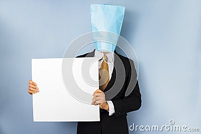 Man with bag over head holding blank sign Stock Photo