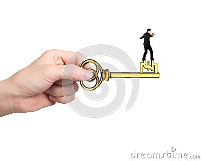 Man balance on treasure key in pound sign shape Stock Photo