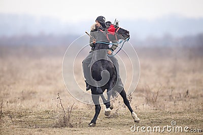 Man is bareback riding an adorned horse before an Epiphany celebration horse race Editorial Stock Photo