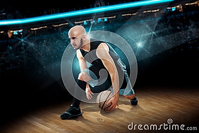 Man in basketball action game dribbles Stock Photo